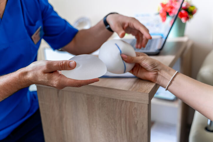 Doctor showing silicone implants