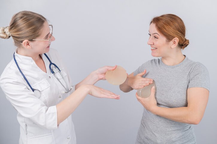 woman trying on breast implants